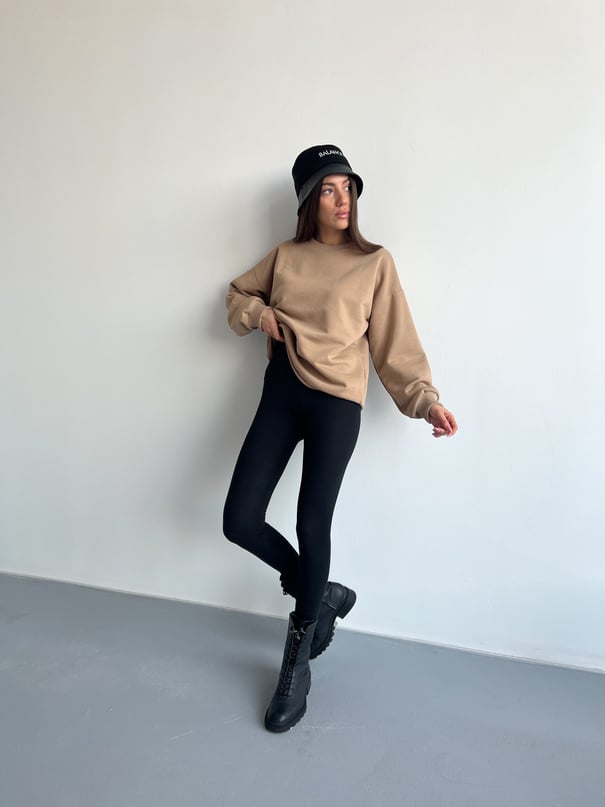 Woman in Brown Sweatshirt and Black Pants